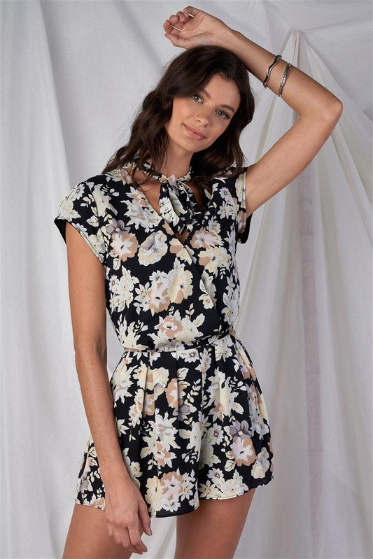 Black Multi Color Floral Print V-Neck Mini Sleeve Tight Fitted Waist Pleated Bottom Romper With Bow Tie Detail - Simpleaholic